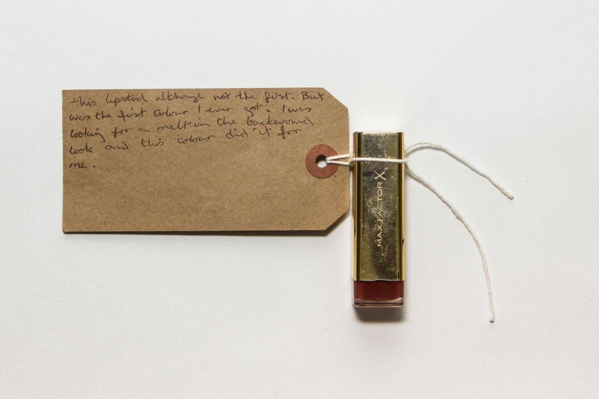 Silver lipstick tube with red stripe on the bottom. "MAX FACTOR X" is written in white text on the front.