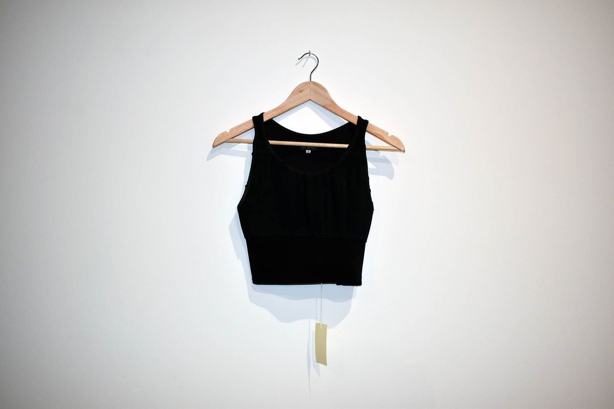 A black full-length binder is laid flat on a hanger.