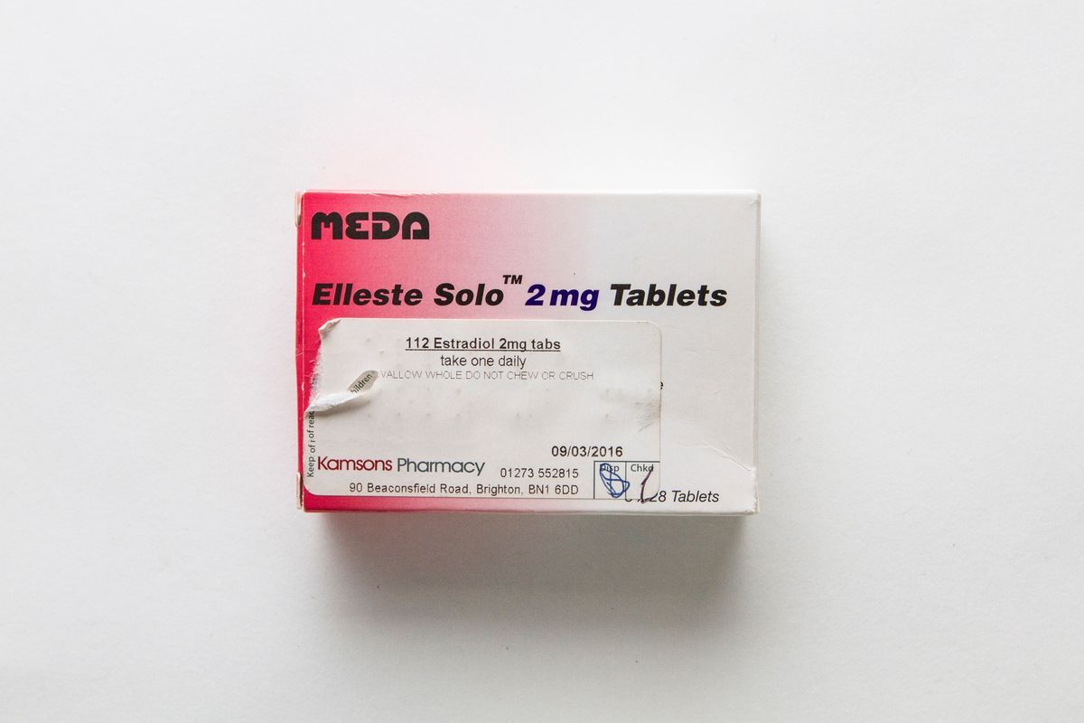 Pink-to-white gradient box reading "MEDA Elleste Solo 2mg Tablets" in black type. There is a prescription label on the bottom left of the front of the box.