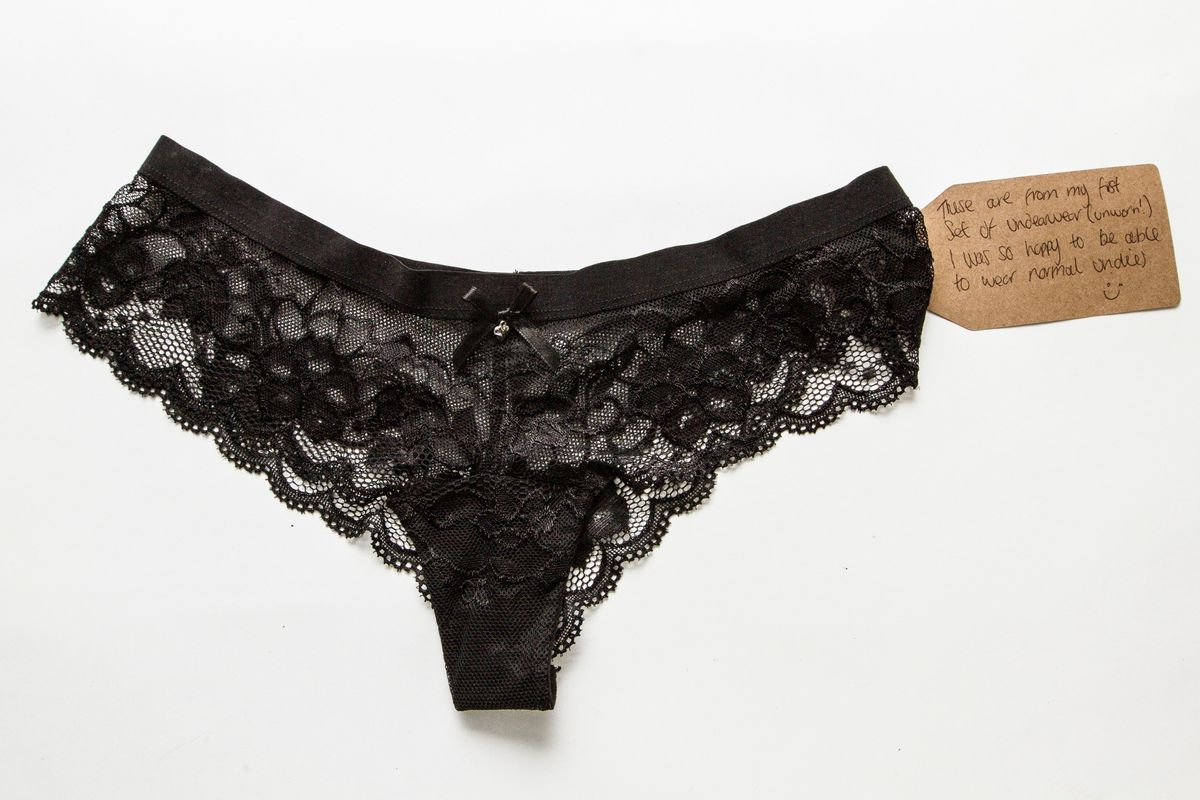 Black lace pants with a brown tag attached to it.