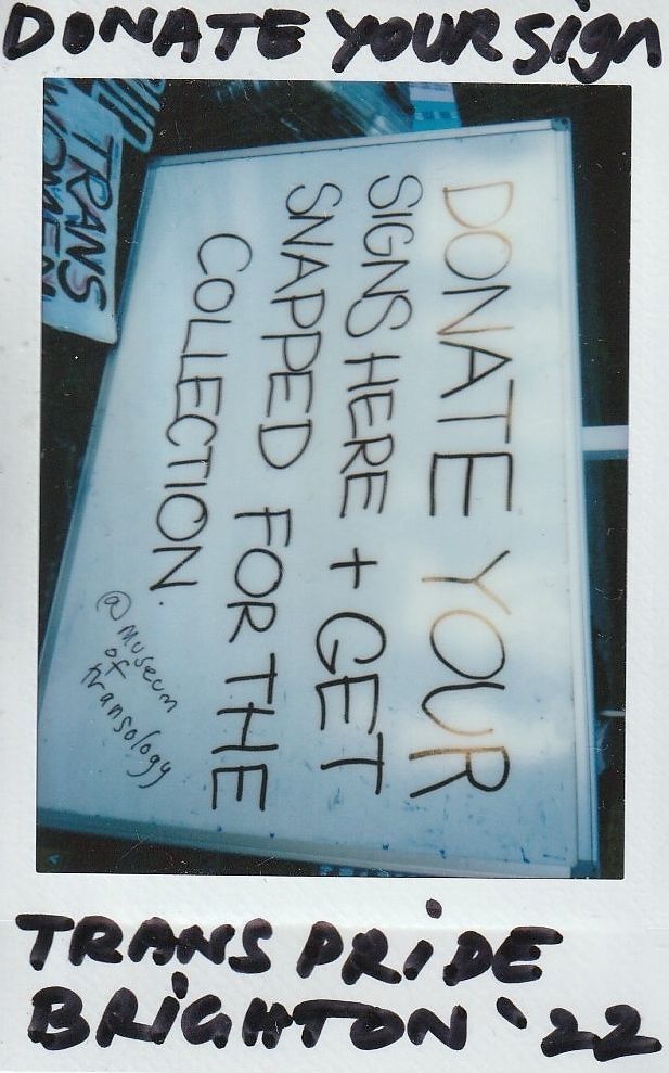 A handwritten sign at Trans Pride Brighton 2022 invites attendees to donate protest signs.