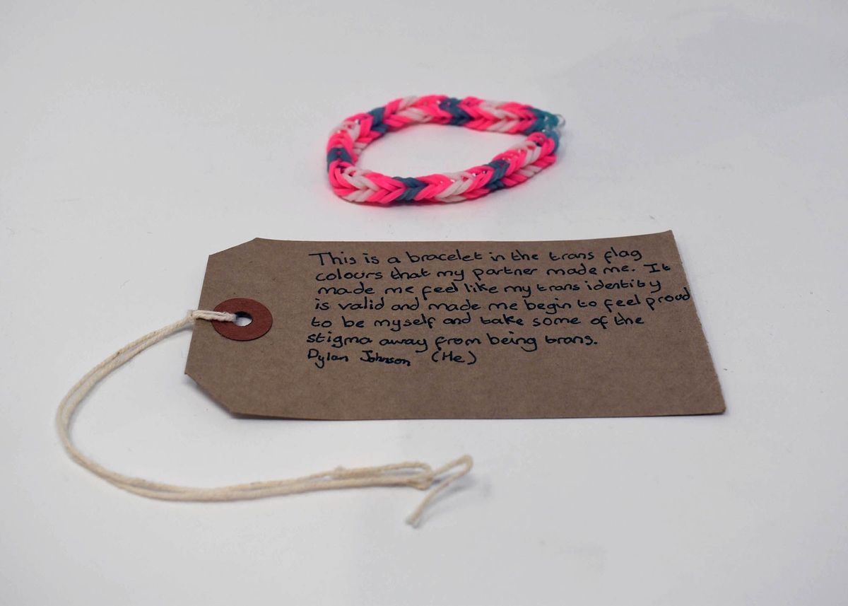 White, pink, and blue bracelet made of loom bands and secured with a plastic "S" clip.