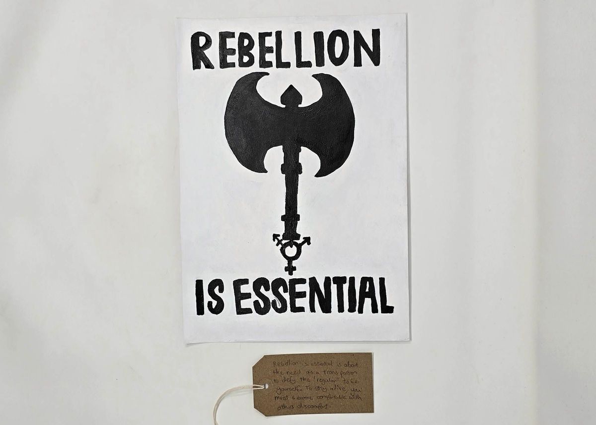 The image features a poster stating "Rebellion is Essential" with an axe design.
