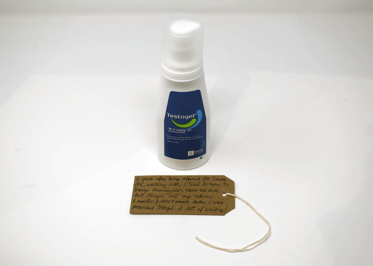 A bottle labeled "Testogel" stands beside a handwritten note on a tag.