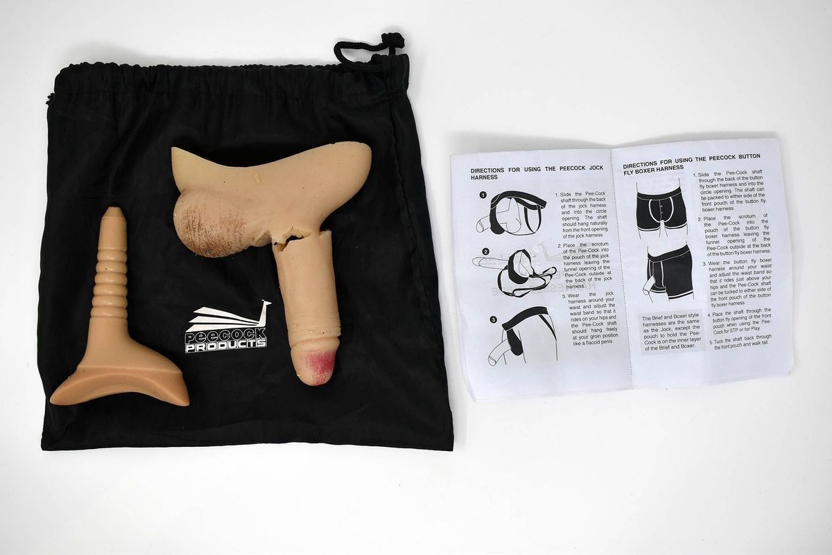 A Peecock Stand to Pee packer with insert. The packer has been broken. With a black satin bag and instruction leaflet.