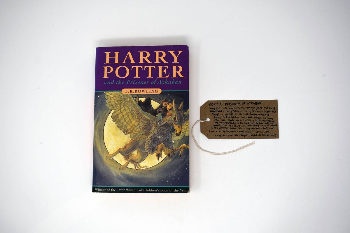 The image shows a copy of "Harry Potter and the Prisoner of Azkaban" with a handwritten tag beside.