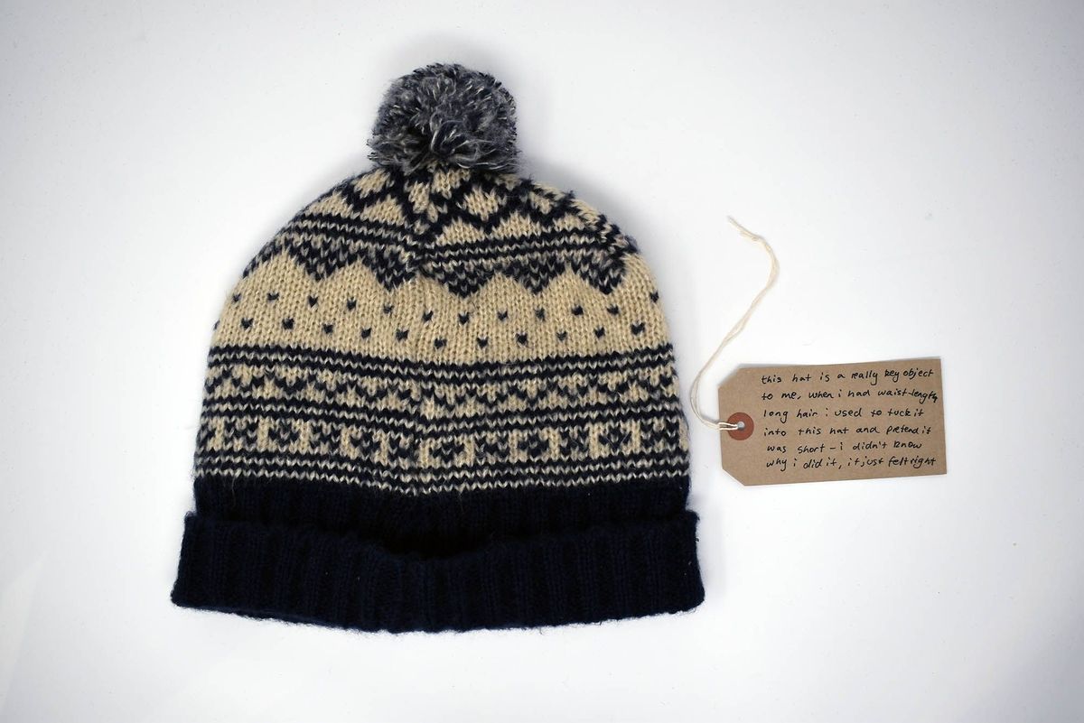 Knitted bobble hat with navy and white pattern.