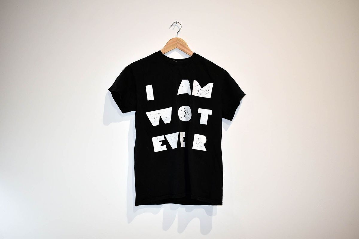 A black T-shirt with bold white text saying "I AM WOT EVER".