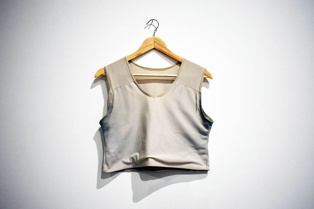 A grey binder on a wooden hanger.