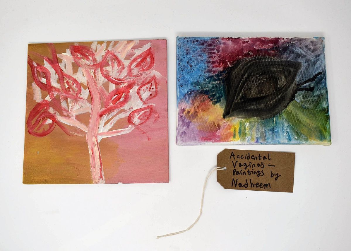 Two colourful paintings, one of a tree, one of a leaf. The leaves resemble vaginas/vulvas.  With a brown handwritten luggage tag.