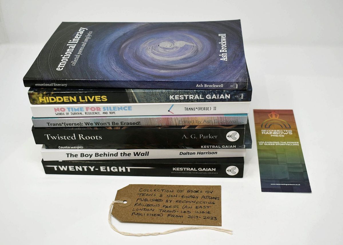 A stack of books with diverse themes is accompanied by a bookmark and handwritten note.
