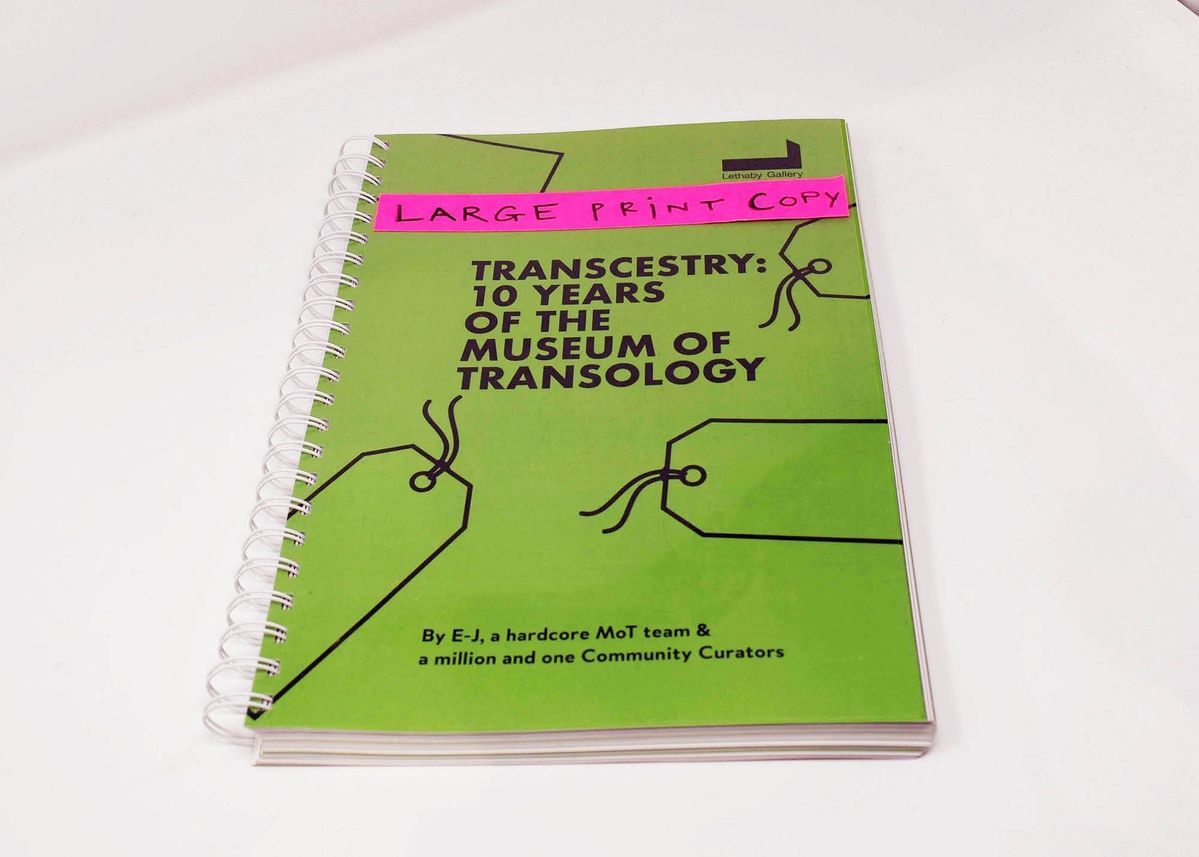 The image shows a spiral-bound book titled "Transcestry: 10 Years of the Museum of Transology".