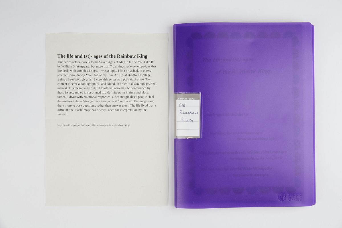 A purple document folder titled "The Rainbow King" rests beside a descriptive page.
