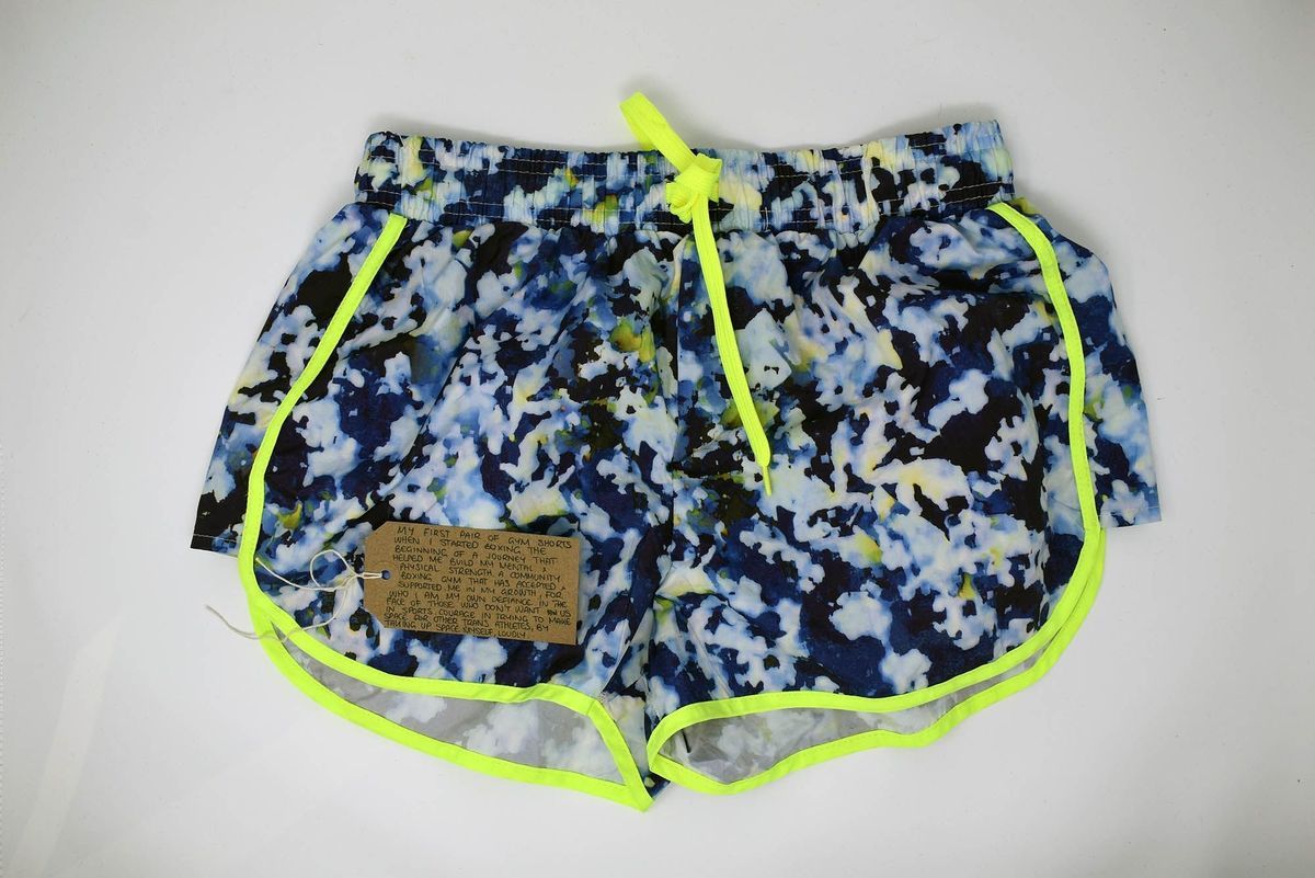 These are colorful gym shorts with neon yellow trim, accompanied by a handwritten note attached.