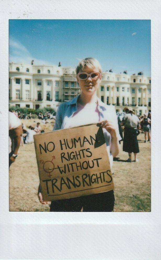 A person holds a sign which says "No Human Rights Without Trans Rights".