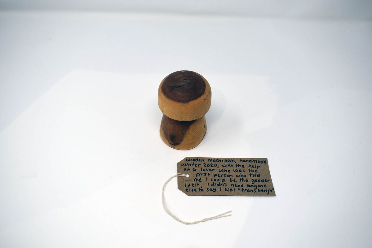 A handmade wooden mushroom. With a brown, handwritten luggage tag.