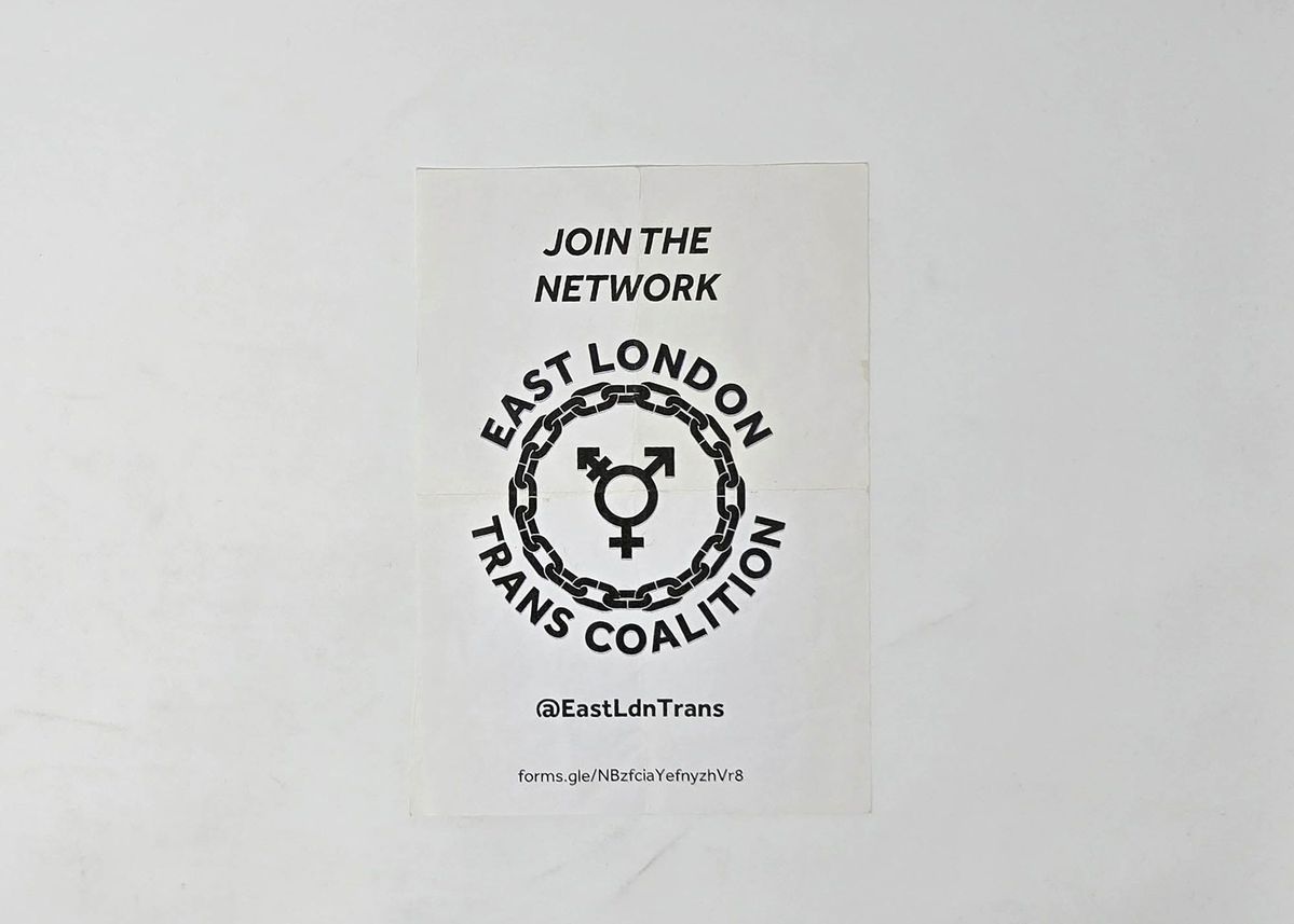 White leaflet with black lettering reading "JOIN THE NETWORK" and "EAST LONDON TRANS COALITION" in a circle around a chain with the gender diversity symbol in the middle. Underneath there is text reading "@East LdnTrans" and a link to a form
