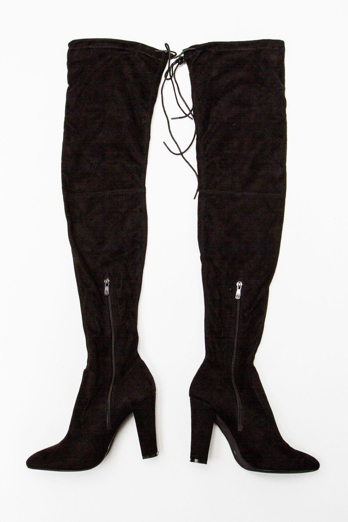 The image features a pair of black, high-heeled over-the-knee boots with zippers