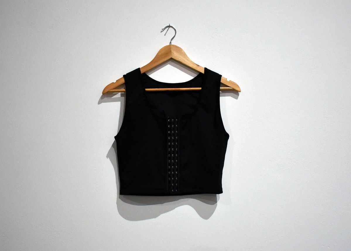 A blank binder hung on a wooden hanger.