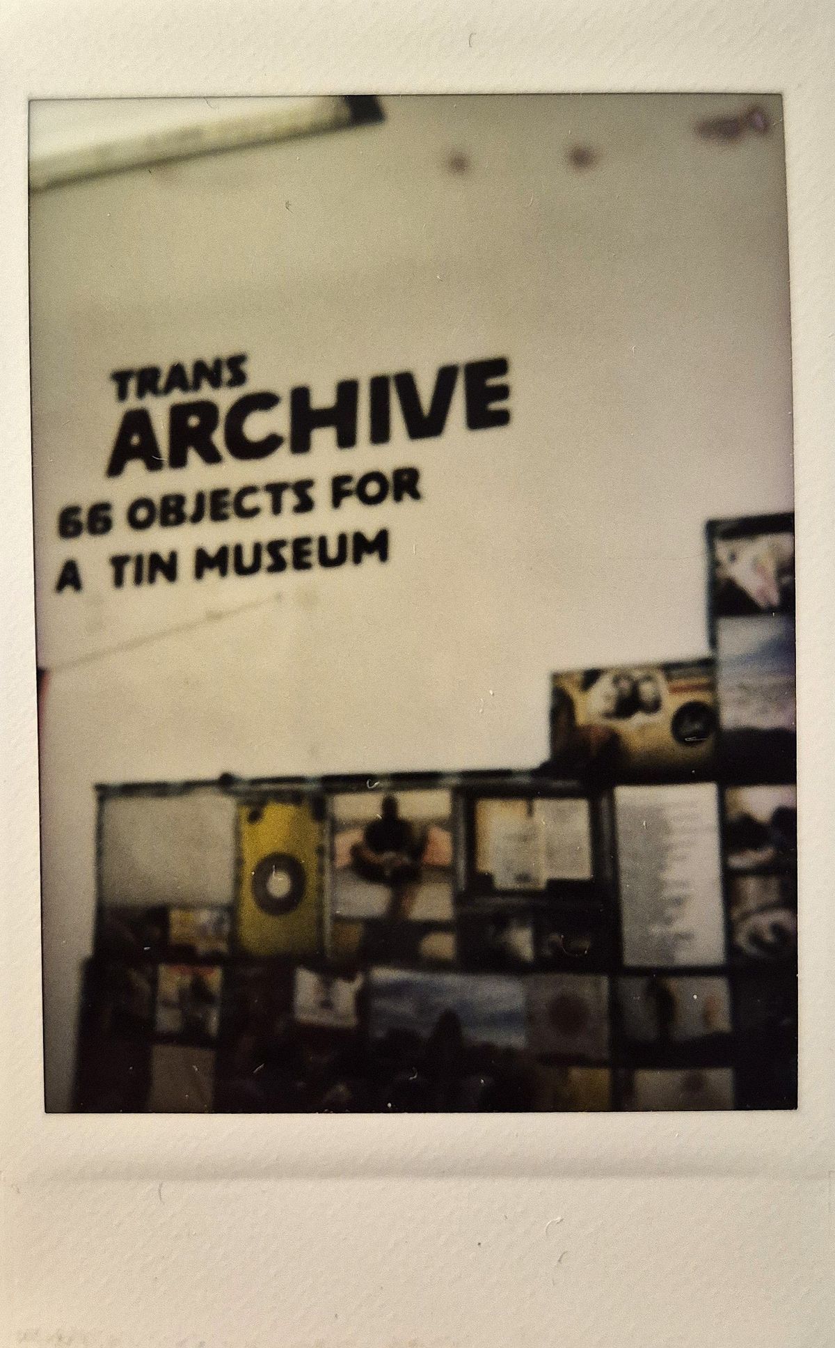 The image shows a wall display titled "TRANS ARCHIVE".