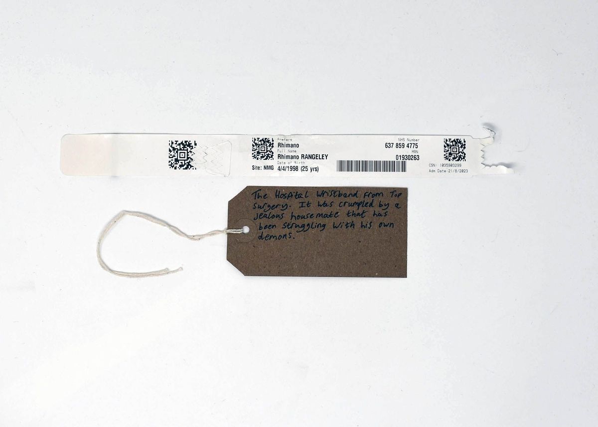 A crumpled hospital wristband and tag describe a surgery and personal struggle.