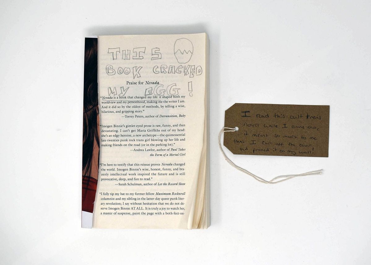 A book with the front page cut off with handwritten text on the pages.