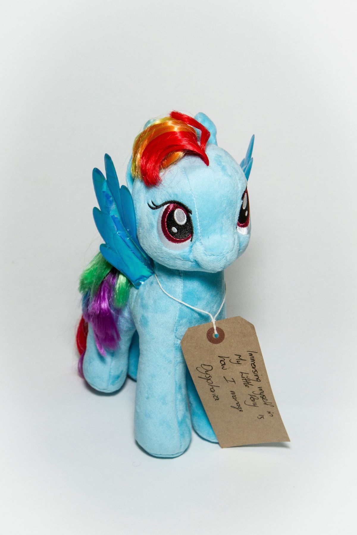 Light blue soft toy horse/pony, specifically the character "Rainbow Dash" from My Little Pony. The toy is clean and the hair/mane is straight and appears well kept.