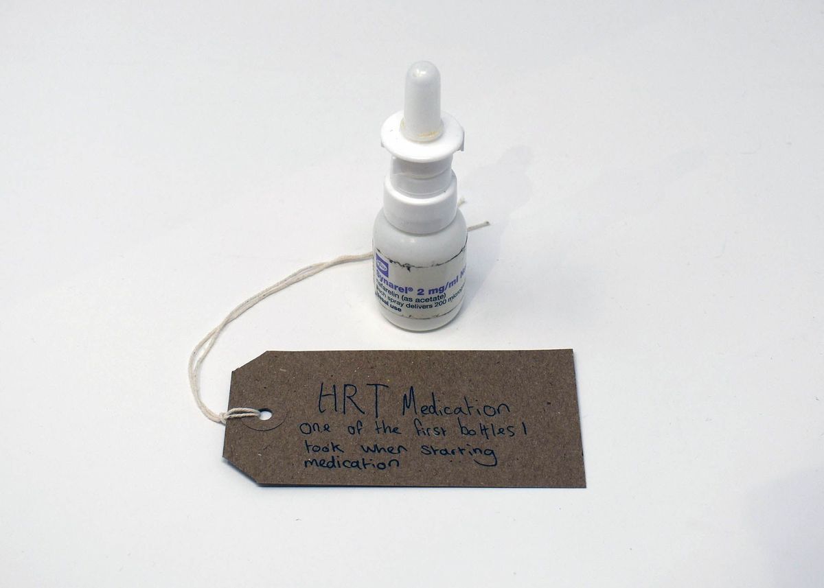 A labeled HRT medication bottle sits beside a handwritten note.