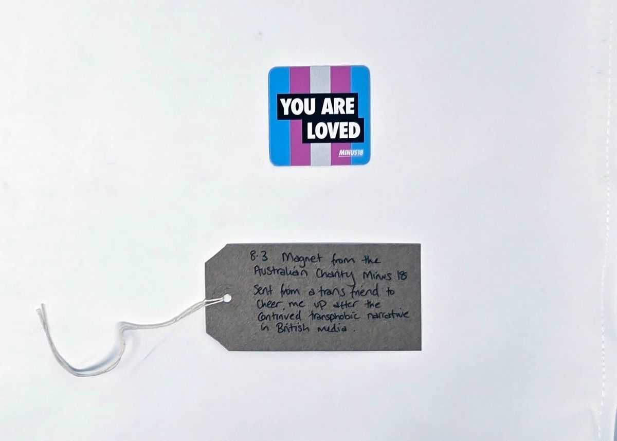 The image shows a "You Are Loved" magnet from Minus18 beside a handwritten note.
