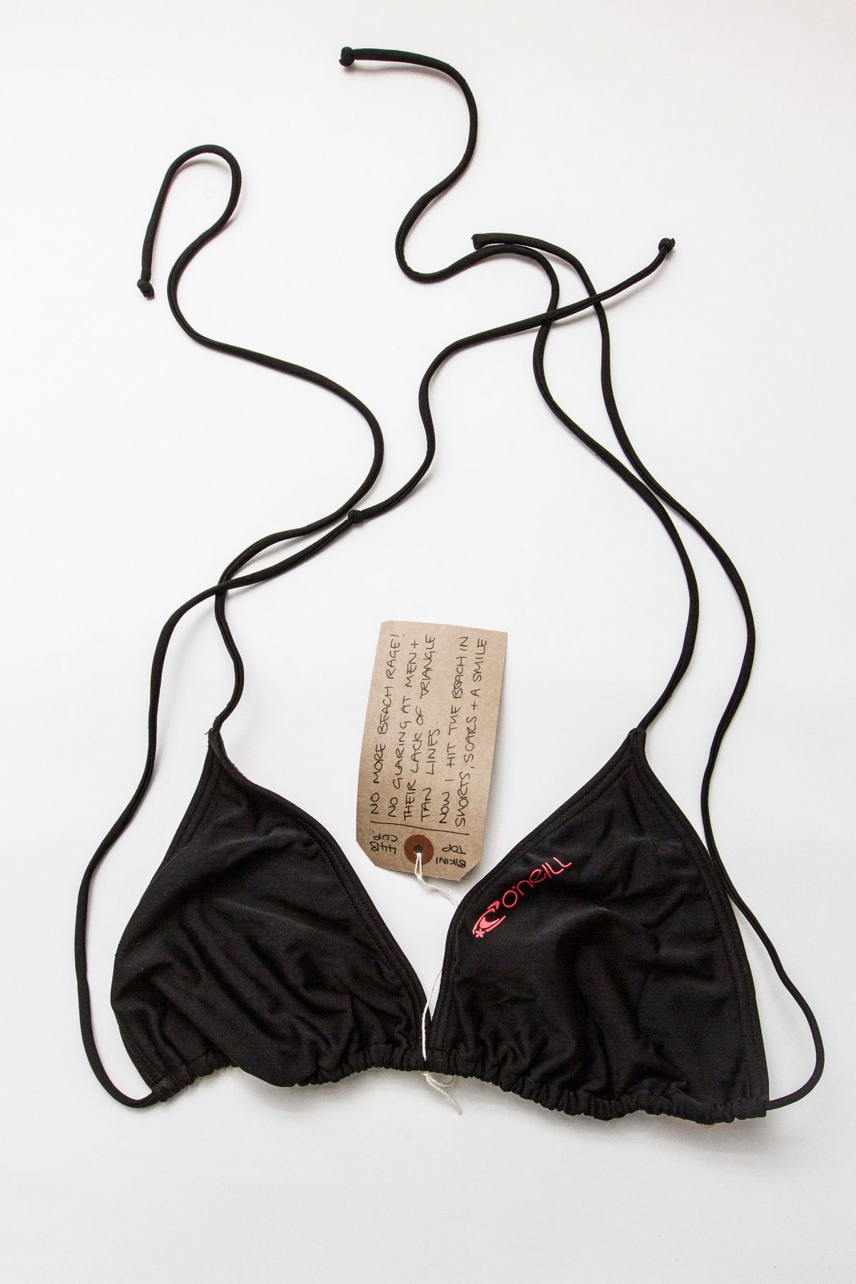 The image shows a black bikini top with string ties and an O'Neill brand logo on the left cup.