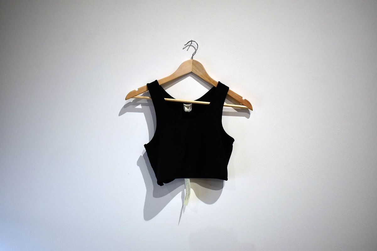 A black binder hung on a wooden hanger.