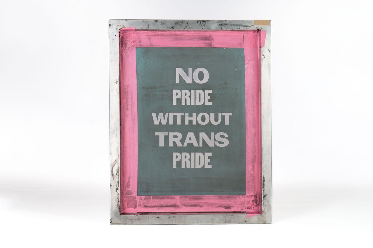 The image displays a printing screen with the words, "No Pride Without Trans Pride," framed in pink.