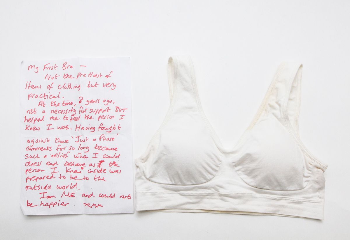 White sports bra with a letter on the left with writing in red pen.