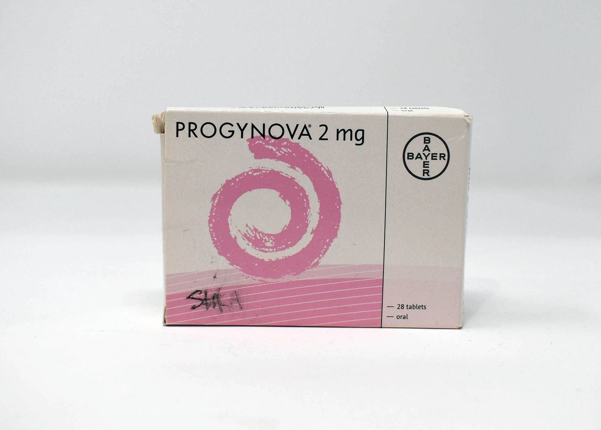 A box of Progynova 2 mg. The box is white with a pink swirl. The donor's name, Shika, has been written in pen in the bottom left corner. This text has smudged.