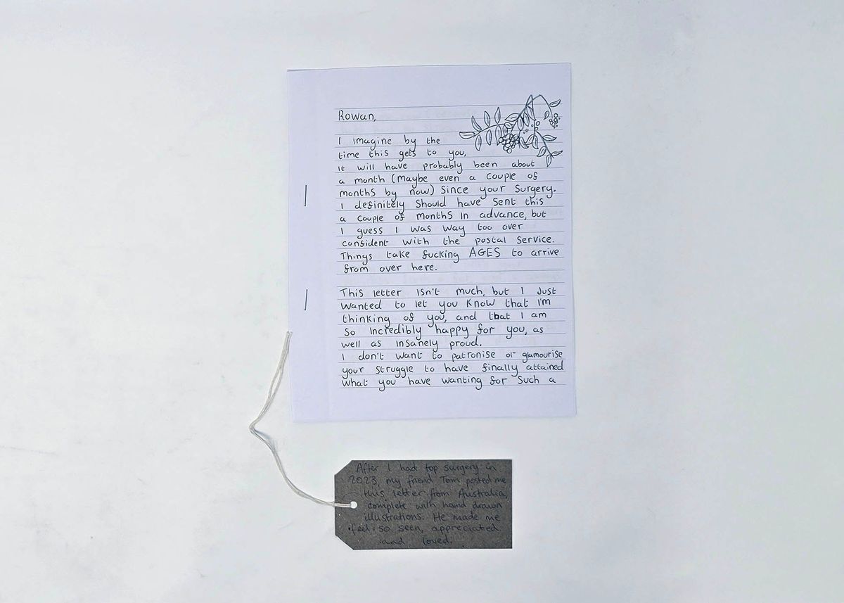 A letter writing about top surgery and a brown luggage tag.