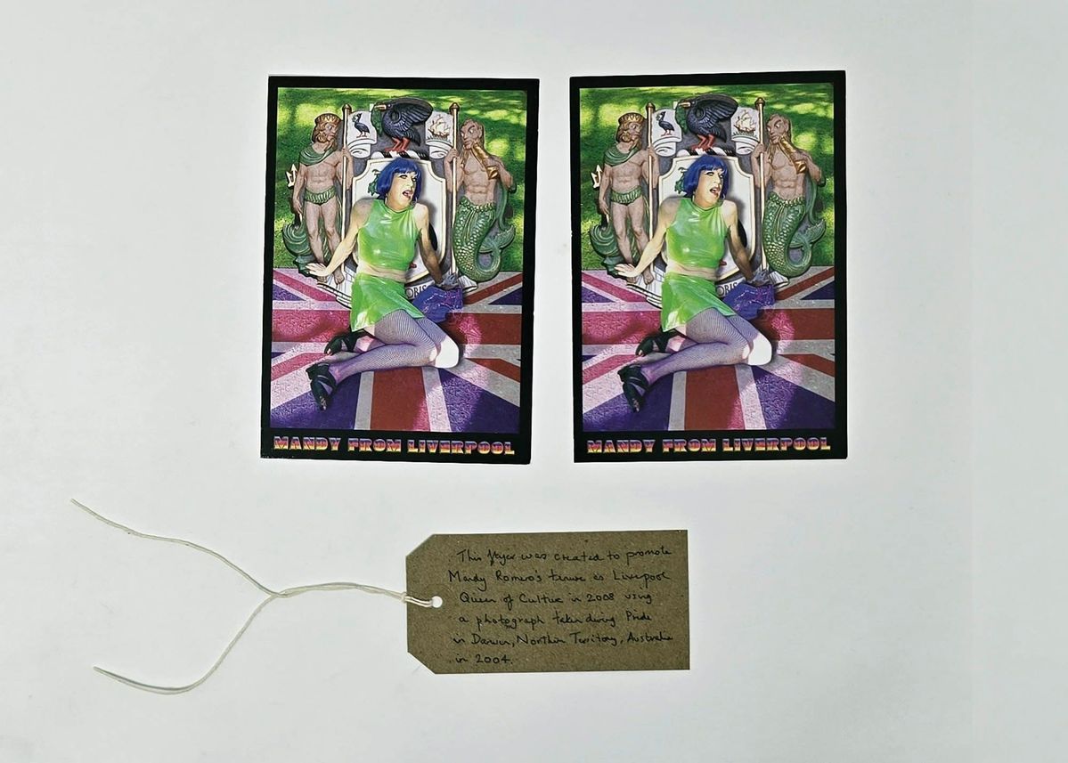 Two identical promotional flyers for a "Mandy from Liverpool" event. The depict a person with blue hair wearing a green top and short skirt. With a brown, handwritten luggage tag.