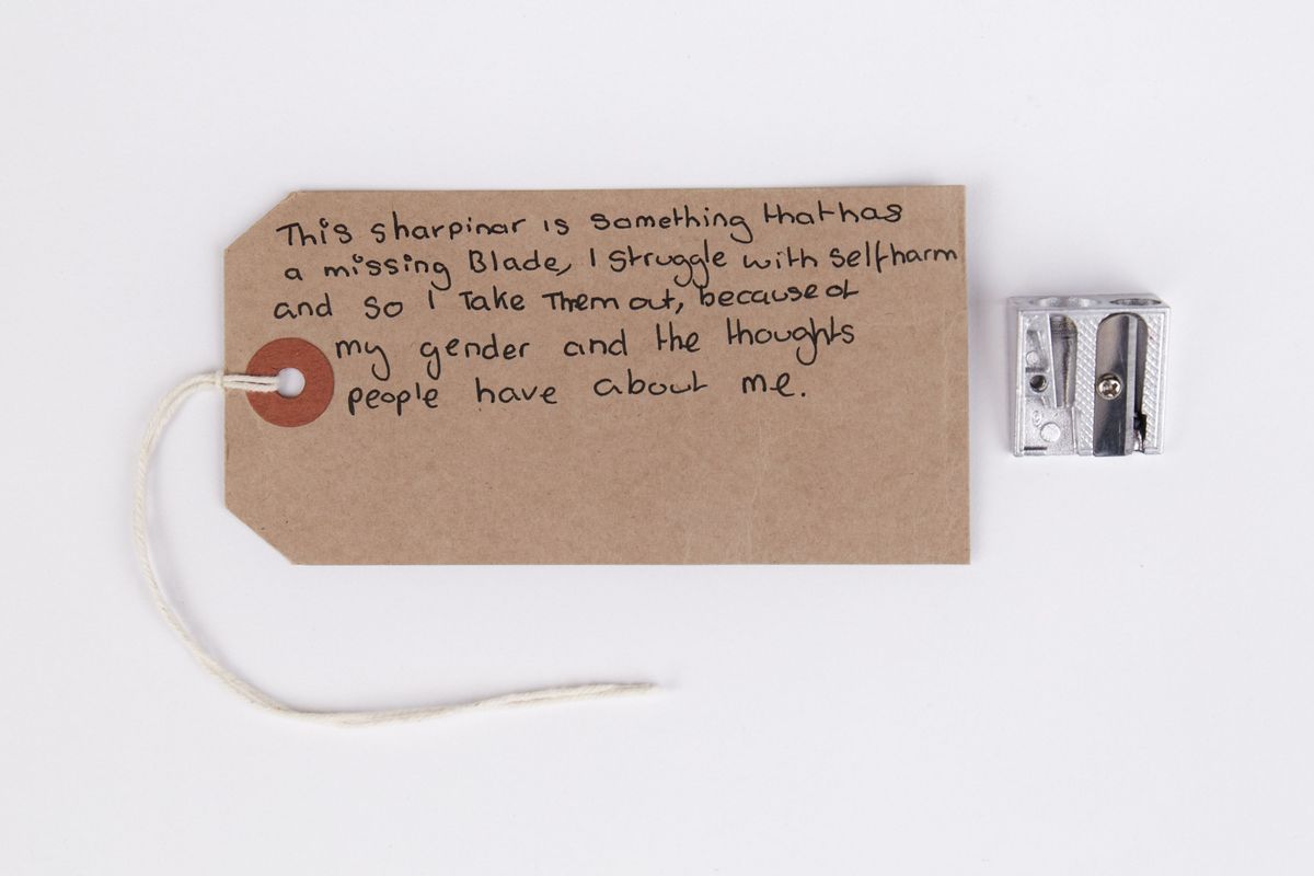 Metal double pencil sharpener & 1 tag; blade of larger aperture has been removed.