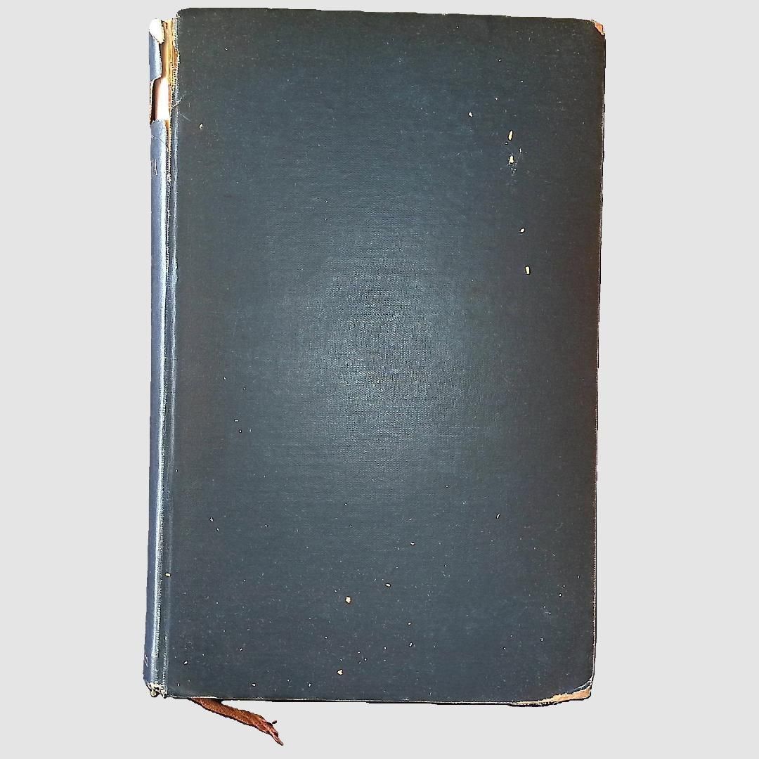 Front Cover; The image shows an old, hardbound book with a dark green cover that has visible signs of wear, including small scratches and scuffs across its surface, and a slightly frayed spine at the top and bottom, indicating its age and extensive use over time; a small piece of brown ribbon protrudes from the bottom of the book, serving as a bookmark, adding a touch of vintage charm to its overall appearance, while the book rests against a plain, light gray background, allowing its details to stand