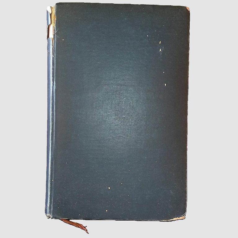 Front Cover; The image shows an old, hardbound book with a dark green cover that has visible signs of wear, including small scratches and scuffs across its surface, and a slightly frayed spine at the top and bottom, indicating its age and extensive use over time; a small piece of brown ribbon protrudes from the bottom of the book, serving as a bookmark, adding a touch of vintage charm to its overall appearance, while the book rests against a plain, light gray background, allowing its details to stand