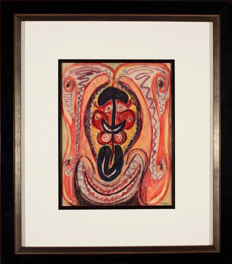 Abstract shapes and bold colors, primarily red, black, and yellow, creating a mask