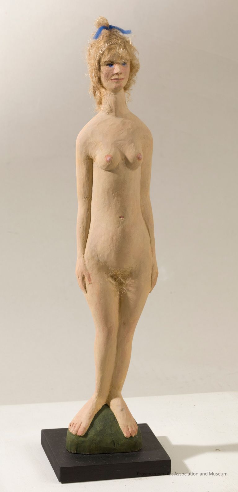 Nude woman with blue bow in her hair