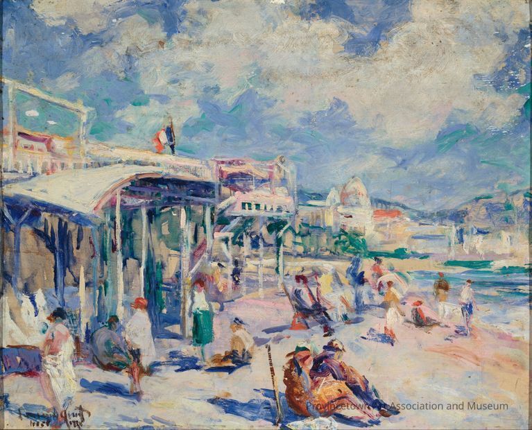 People sitting and standing along the shore