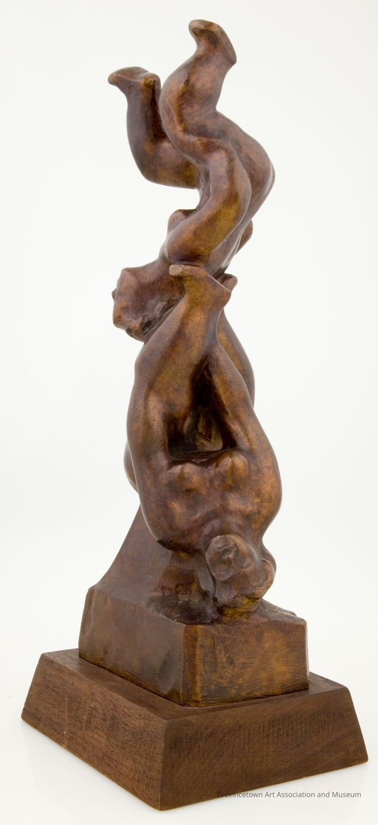 Two people balancing on their backs, one on top of the other