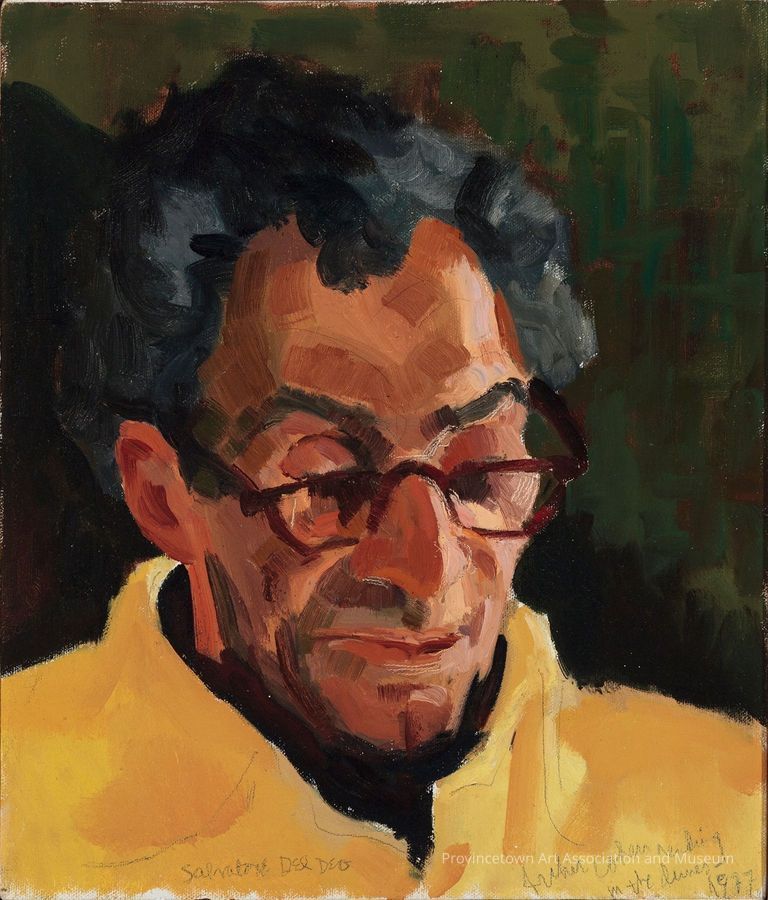 Portrait of man in glasses looking down, in yellow jacket