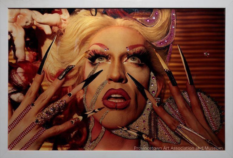 Bedazzled photo of drag queen Acid Betty (from RuPaul's Drag Race season 8) looking up with hands to her face and long stiletto nails