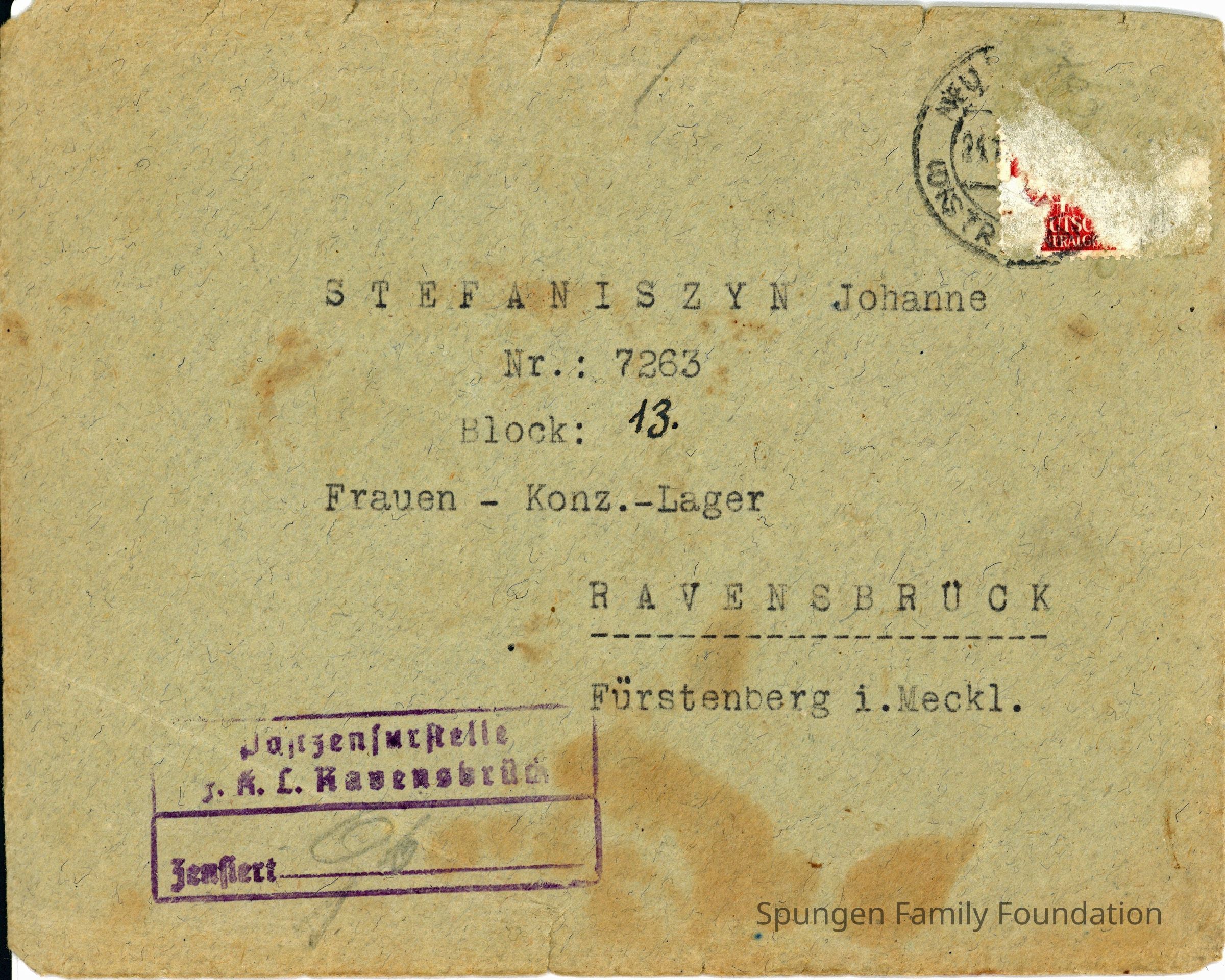 1943 November 23, Front side - Cover from Ravensbrück women's concentration camp addressed to Eufemii Stefaniszyn's daughter Jasiu/Johanne.: Tan-green cover with printed address in German using black ink. The recipient's address is Johanne Stefaniszyn. At the top right is residue and remnants of a ripped red Detusches Reich stamp. Over top is a cancellation stamp though the right half of the stamp was removed with the red stamp. The bottom left feature a purple stamp in German which reads "Postzensurstelle f.k.L. Ravensbrück Zonsiert" or "Postal censorship office f.k.L. Ravensbrück Censored". The paper is stained brown scattered overall.