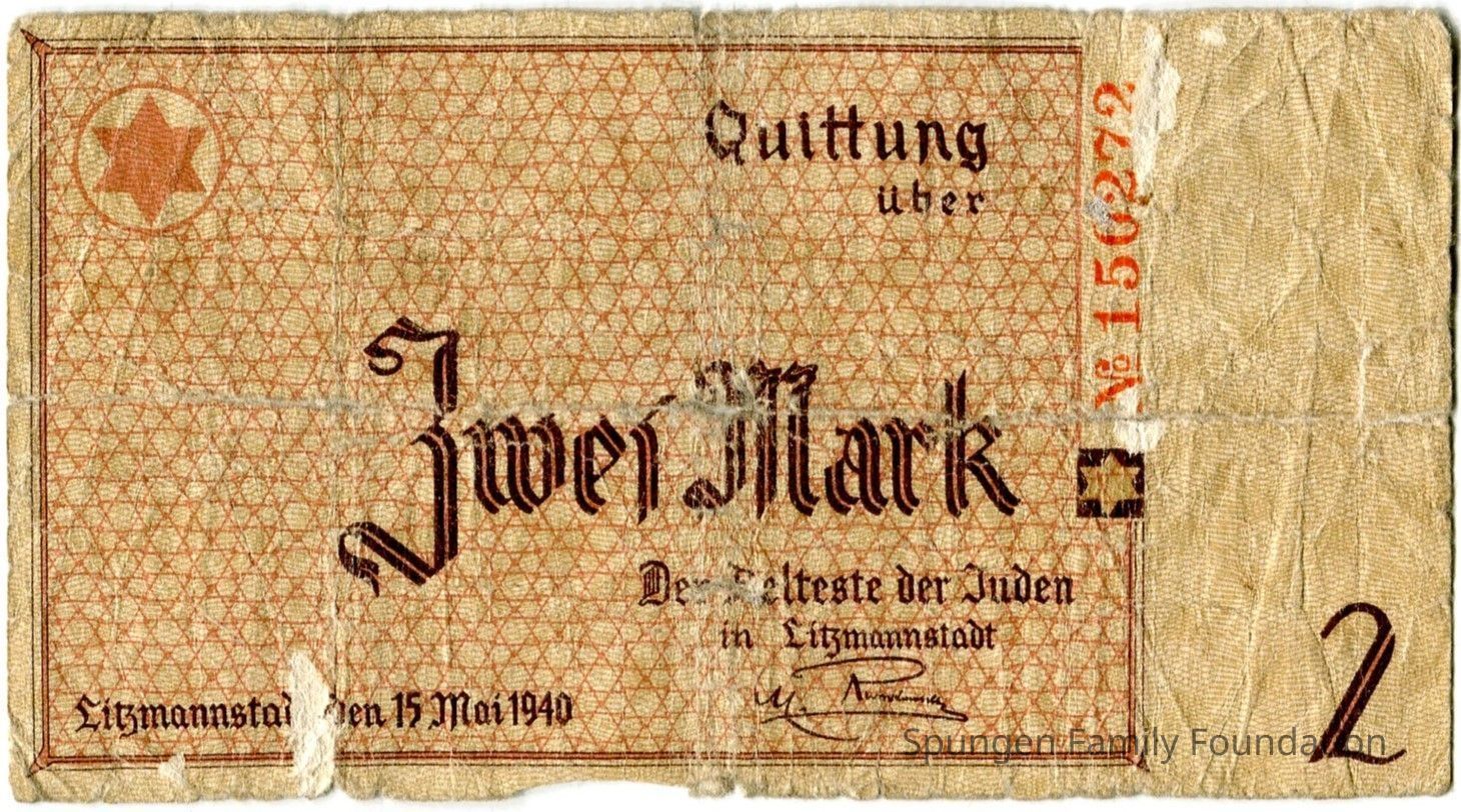 1940 May 15, Front side - Scrip worth 2-marks from Łódź (Litzmannstadt) Jewish ghetto.: Tan paper with printed text and outline in brown and red ink. At the top left corner, the Star of David in red ink. The background of the print is a repetitive star pattern. At the center, "Zwei Mark" is printed in brown ink. At the bottom right, the number "2" in brown ink. At the bottom center, a printed signature in brown ink. At the top right, a serial number in red ink, "No. 150272" is present.