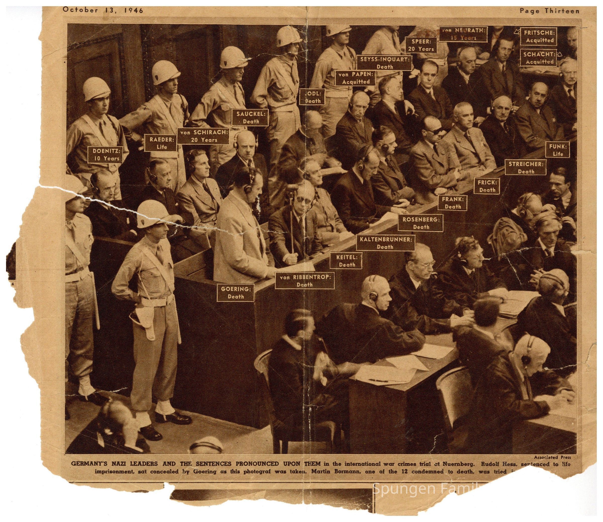 1946 October 13, Front side - Newspaper clipping from the Chicago Sunday Tribune featuring the Nuremberg Trials.: Tan and brown newspaper clipping with sepia photograph depicting twenty (20) Nazi Party defendants at the Palace of Justice in Nuremberg, Germany. The photo features United States Army Military Police Officers standing positioned around the Nazi leaders, who are sitting, many with headphones on. Hermann Göring is standing. Printed text in English using brown ink is present.