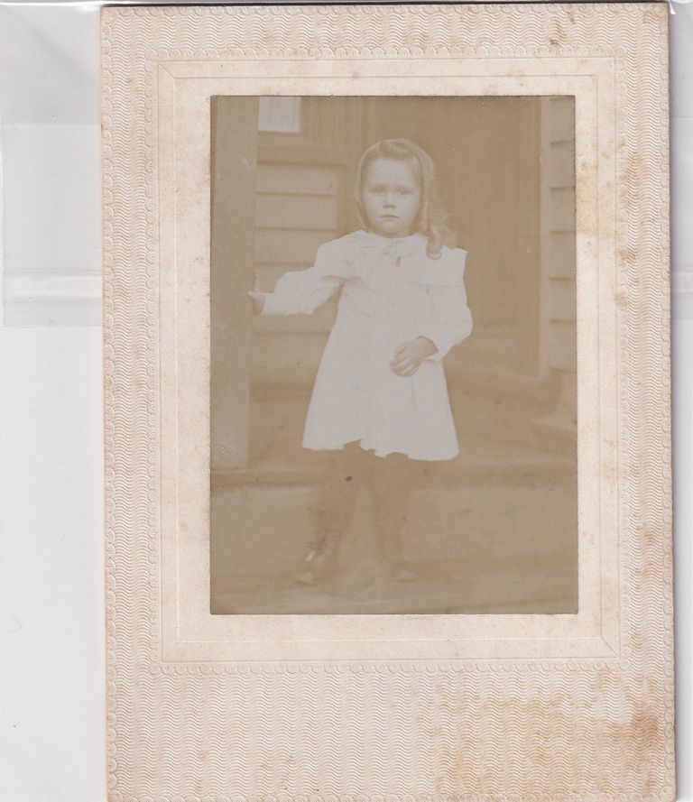 Portrait of Young Girl Standing on Porch Steps