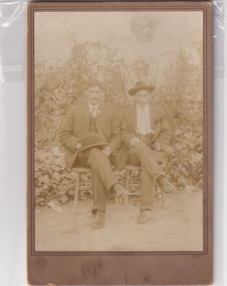 Two Seated Gentlemen in Outdoor Setting